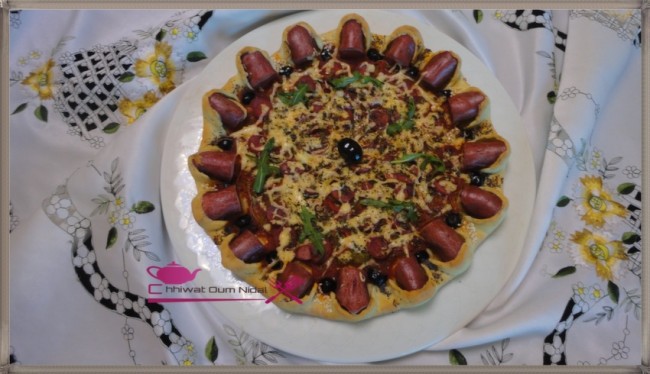 pizza strasbourg, chhiwate, cuisine oum nidal, recette, salée, hotdog, hot dog, sauce tomate, cuisine marocaine, شهيوات مغربية, أم نضال, وصفة, أطباق مالحة, صلصة الطماطم, ستراسبورغ, هوت دوغ, جرجير